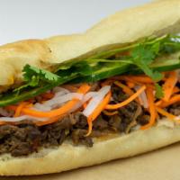 Bulgogi Beef Sandwich · Marinated ribeye, caramelized onion, kimchi aioli. Comes with pickles carrots and daikon, cu...