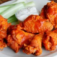 Buffalo Wings · Crispy and golden fried wings glazed with spicy, classic Buffalo sauce.