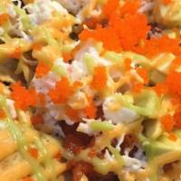 Mioki Nachos · Spicy tuna, chips, crab, avocado, tobiko & house sauce.