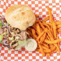 Butifarra · Pork sandwich with marinated onions, lettuce and sweet potato fries.