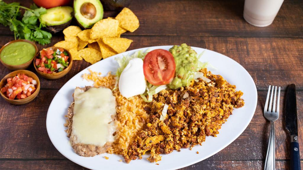 1. HUEVOS CON CHORIZO · Three scrambled eggs with chorizo, served with rice, refried beans & tortillas.