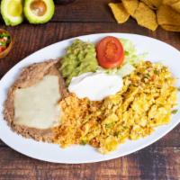 2. HUEVOS A LA MEXICANA · Three scrambled eggs with tomatoes, onions and jalapeno. Served with rice, beans & tortillas.
