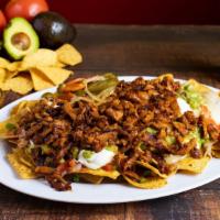 Super Nachos · Chips, beans, cheese, jalapeños, guacamole, sour cream & choice of meat.