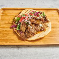 Beef + Lamb Gyro Pita · Grilled perfect pita, thinly sliced rotisserie lamb and beef gyro, spicy aioli, arugula, let...