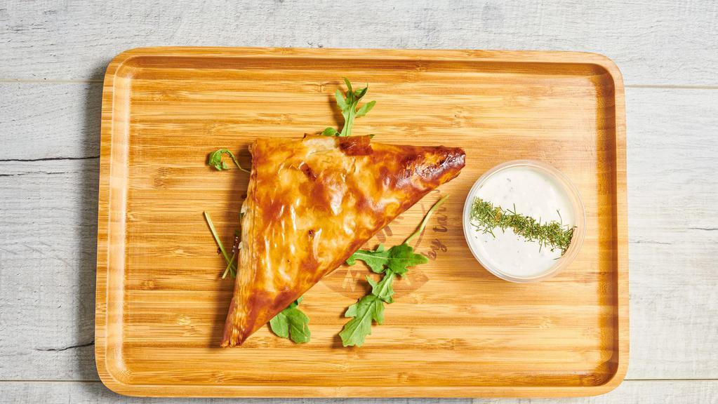 Spanakopita · Phyllo dough stuffed with spinach and feta, served with tzatziki