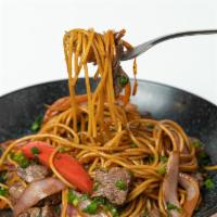 Asian Stir Fried Pasta · Pasta stir-fry with juicy sirloin beef, tomatoes, red onions, cilantro, spring onions & yell...