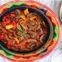 Ingudai / Mushroom Tibs (IMT) · Cremini mushrooms, onions, tomatoes, ginger, garlic, berbere, and spices.
