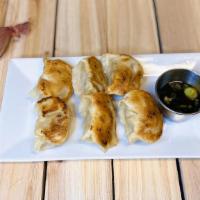 Pan Fried Pork Potstickers · Pork filled with cabbage, green onions, and garlic. Serve with chili soy ginger sauce (df).