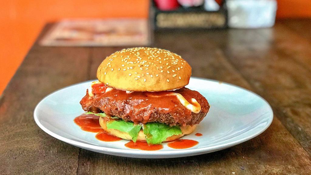 Buffalo Chicken Burger · Classic chicken burger topped with spicy buffalo sauce, fresh lettuce, cheese, tomatoes, and mayo stuffed in between a fresh baked bun.