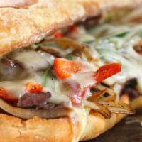The Philly Cheesesteak · Thinly sliced steak, grilled mushrooms, onions, bell peppers, and creamy cheese stuffed in a...