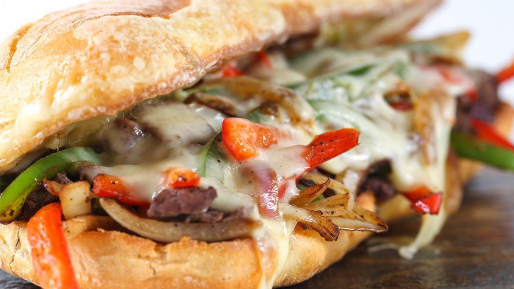 The Philly Cheesesteak · Thinly sliced steak, grilled mushrooms, onions, bell peppers, and creamy cheese stuffed in a homemade fresh roll.
