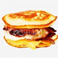 Bacon, Egg & Cheese Pancake Sandwich · Bacon, scrambled egg, and cheddar cheese between two pancakes and served with syrup on the s...