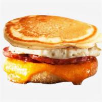 Ham, Egg, and Cheese Pancake Sandwich · Ham, scrambled egg, and cheddar cheese between two pancakes and served with syrup on the side.