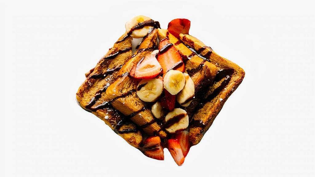 Strawberry Banana Nutella French Toast · Classic French toast with Nutella and topped with strawberries and bananas. Served with syrup on the side.