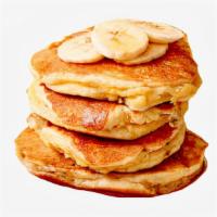 Banana Pancakes · Two large banana pancakes served with syrup.