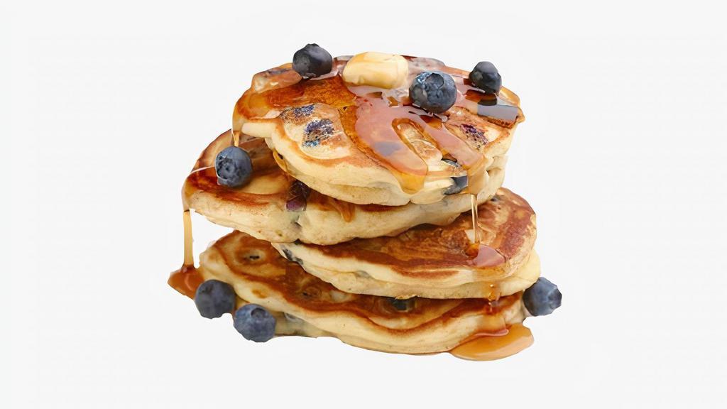 Blueberry Pancakes · Two large blueberry pancakes served with syrup.
