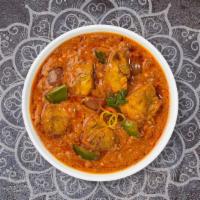 Chicken Karahi · Tender chicken breasts stir fried with bell peppers, onions, & tomatoes in a light gravy