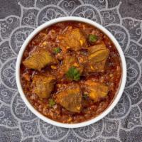 Lamb Achar · Lamb cooked with hot spicy curry sauce, peppers, and pickles.