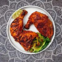 Tandoori Chicken · Juicy chicken dipped in a yoghurt & ground spice marinate and baked in a tandoor clay oven