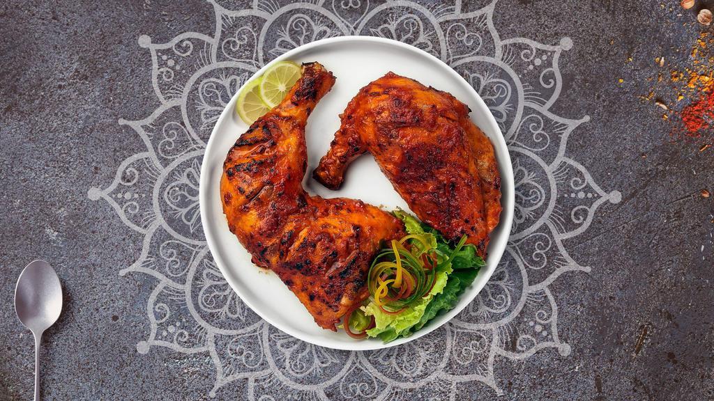 Tandoori Chicken · Juicy chicken dipped in a yoghurt & ground spice marinate and baked in a tandoor clay oven
