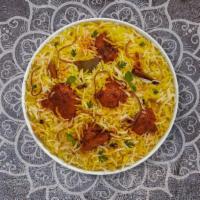 Chicken Biryani · Juicy chicken breasts cooked with Indian spices and basmati rice. Served with house raita.