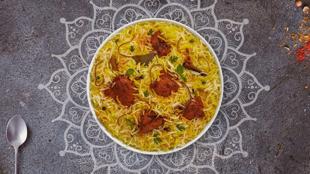 Tandoori Chicken Biryani · Tandoori chicken cubes cooked with Indian spices and basmati rice. Served with house raita.