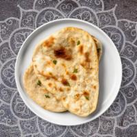 Chili Naan · Freshly baked bread in a clay oven garnished with chili.
