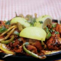 Murgh Tikka Masala · Spiced, boneless chicken pieces with thick onion tomato masala.