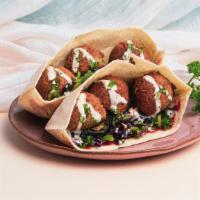 Falafel Eggplant Pita Sandwich · Falafel with grilled eggplant, shredded cabbage, chopped parsley, and red harissa wrapped up...