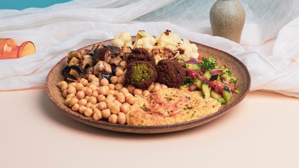 Hummus Veggie Plate · Hummus with falafel, grilled eggplant, charred cauliflower, and Israeli salad.