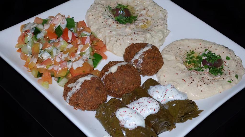 Baba Ghanoush Falafel Plate · Baba ghanoush with falafel and chopped parsley, drizzled with olive oil and topped with a sprinkle of paprika.