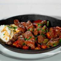 Yogurtlu - Beef tenderloin baked & served with yogurt & tomato sauce · Grilled certified angus tenderloin and grilled meatballs served over flatbread with tomato s...