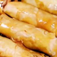 Turon · Thinly sliced bananas, dusted with brown sugar, rolled in a spring roll wrapper.