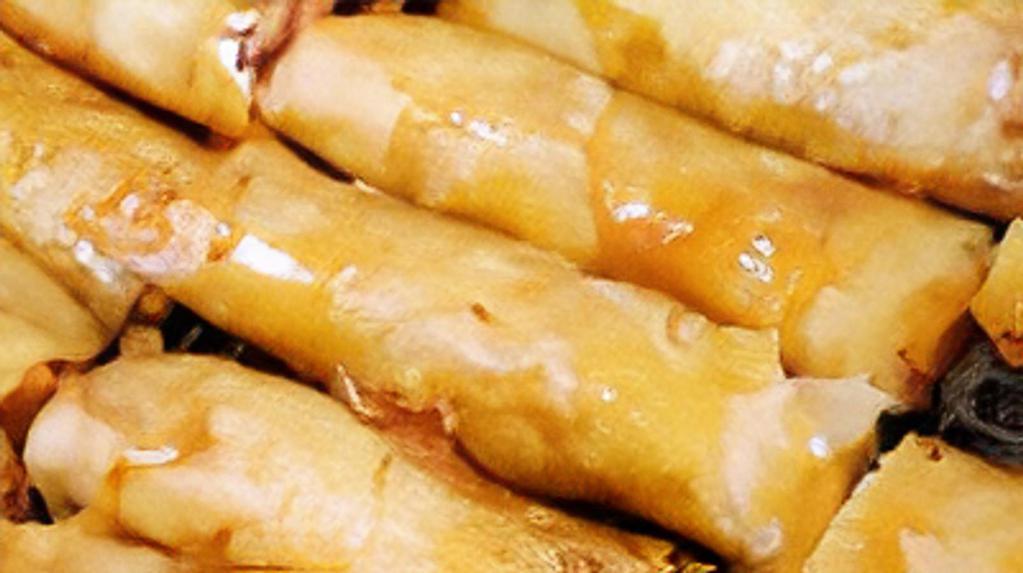 Turon · Thinly sliced bananas, dusted with brown sugar, rolled in a spring roll wrapper.