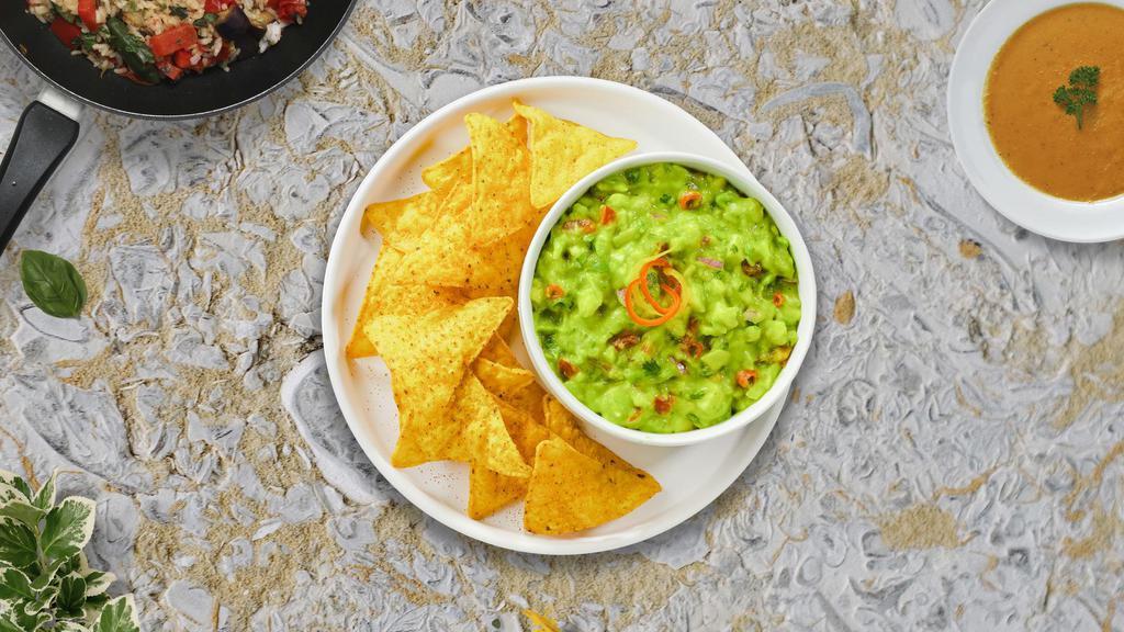 Team Guacamole & Chips · A heaping scoop of fresh guacamole and warm tortilla chips.