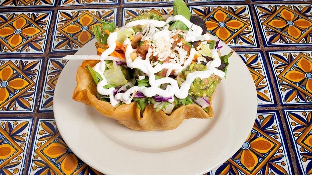 Taco Salad · Mixed greens, rice, beans, with crema, guacamole, salsa fresca and Monterey jack cheese. Served in a crispy flour tortilla shell with your choice to add veggies, meat, angus steak, or shrimp.