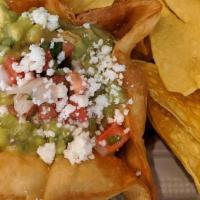 Guacamole And Chips · Fresh avocado, onion, tomato, lime juice, topped with salsa fresca (pico), and queso fresco....