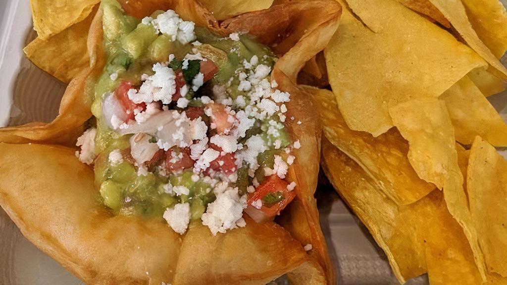 Guacamole And Chips · Fresh avocado, onion, tomato, lime juice, topped with salsa fresca (pico), and queso fresco. Served in a crispy flour tortilla shell with corn tortilla chips.