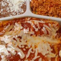 Enchiladas Rojas · 2 corn tortillas with shredded chicken. Topped with our red mild sauce and cheese. Served wi...