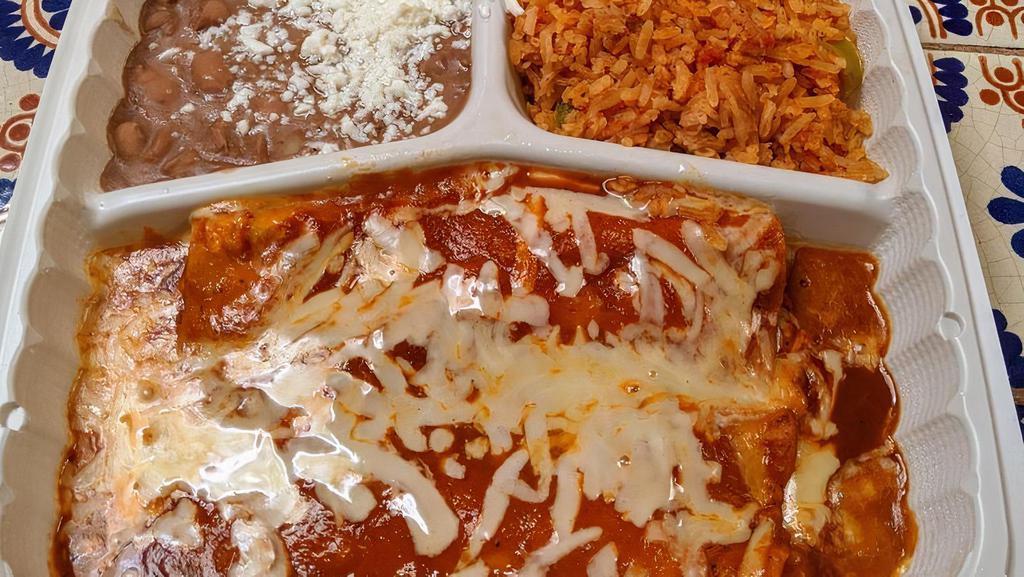 Enchiladas Rojas · 2 corn tortillas with shredded chicken. Topped with our red mild sauce and cheese. Served with rice and refried beans with mexican cheese.