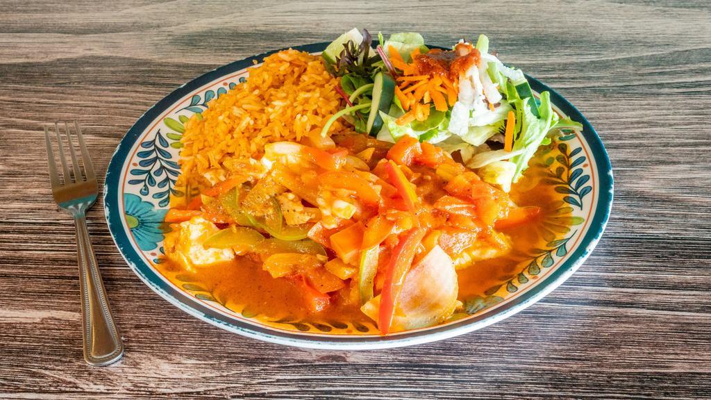 Pescados a La Veracruzana · Tilapia fish fillet simmered in a Veracruz style sauce with capers, green olives, bay leaves, onions, and bell peppers. Served with rice and salad.