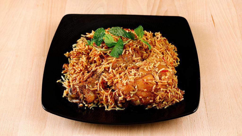 Chicken Biryani · Kyat tha dan pauk. Oven baked bone-in chicken leg on top of biryani rice.