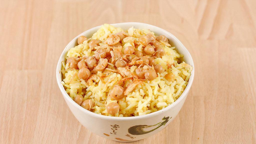Burmese Fried Rice · Fried jasmine rice with turmeric powder, yellow peas, and onion.