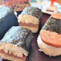 Spam Musubi · A slice of grilled spam on top of a block of rice wrapped together with nori. 
NOTE: We make...