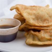 Deep fried pot stickers · Marinated minced chicken breast and vegetables dumpling served with spicy soy sauce.