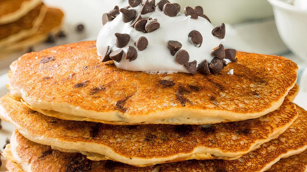 The Chocolate Chip Buttermilk Pancakes · Three pieces of fluffy buttermilk pancakes with fresh chocolate chips bits, served with butter and syrup.