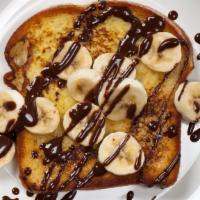 The Banana French Toasts · Three pieces of fluffy french toasts with fresh bananas, served with syrup.