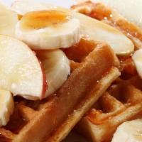 The Banana Belgian Waffles · Belgian style waffle crisp to perfection! Topped with fresh bananas and syrup.