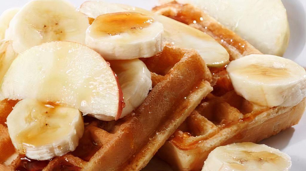 The Banana Belgian Waffles · Belgian style waffle crisp to perfection! Topped with fresh bananas and syrup.