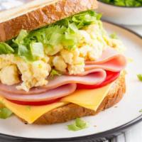 The Ham & Cheese Scrambled Eggs · Sizzling fresh ham, eggs and cheese scrambled eggs. Served with side of hash browns, house p...